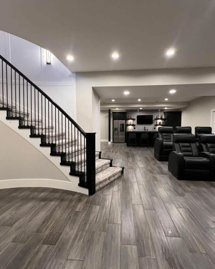 Finished basement family room with theatre seating, wet bar and wood-look plank flooring in Scarborough